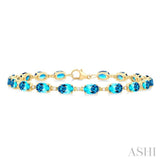 6X4 MM Oval Cut Blue Topaz and 1/6 Ctw Round Cut Diamond Semi-Precious Tennis Bracelet in 10K Yellow Gold